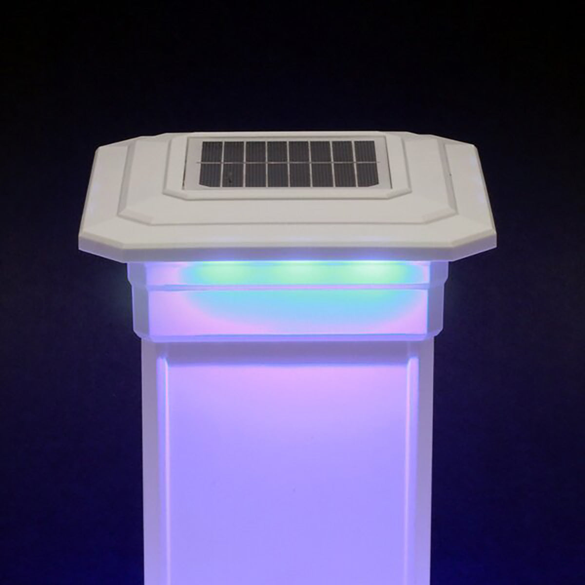 Solar-powered LED light post with colorful illumination on a dark background