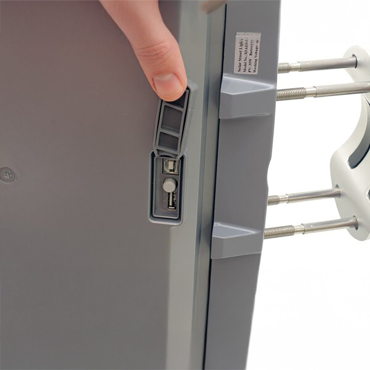 Close-up of a refrigerator door handle being pressed, with a focus on the mechanism.