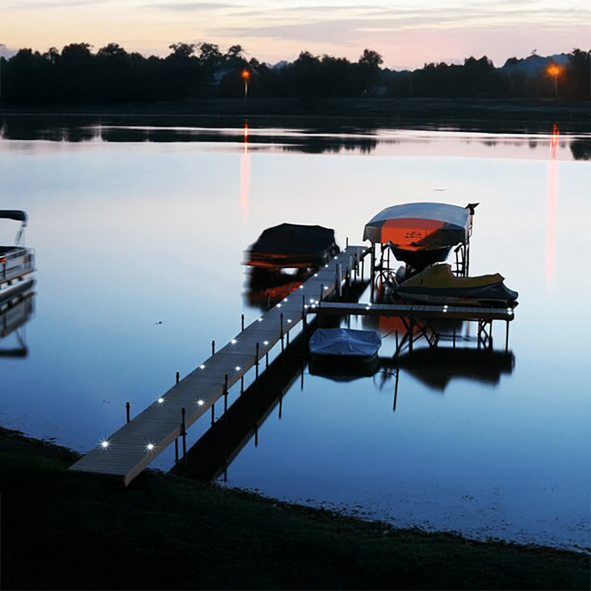 Docks with boats at sunset on a calm lake