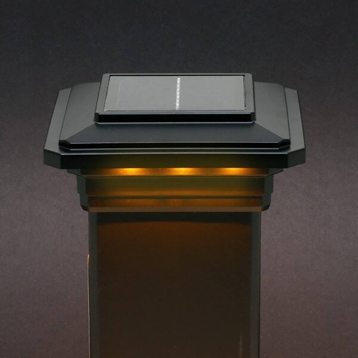 Solar-powered outdoor light fixture on a dark background