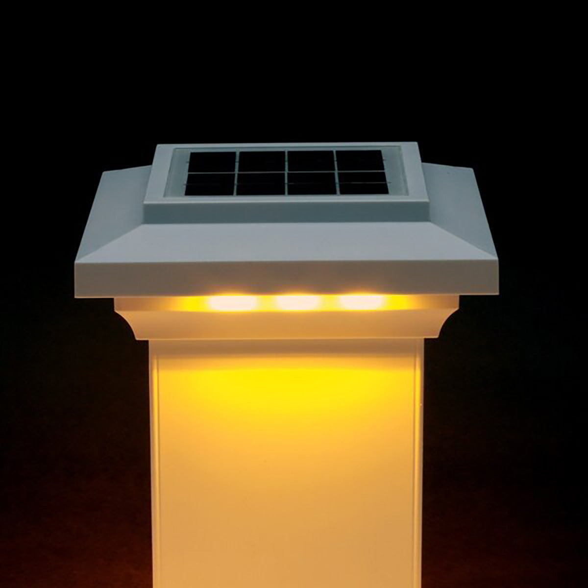 Solar-powered outdoor light fixture with glowing yellow light on a black background