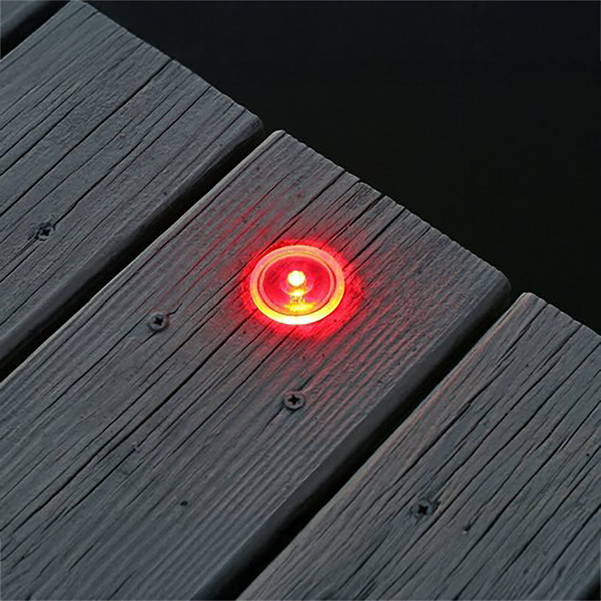 Red LED light embedded in a wooden deck