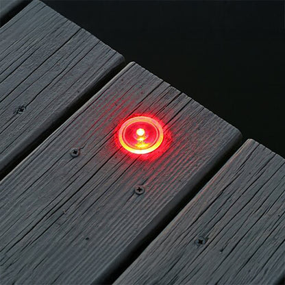Red LED light embedded in a wooden deck