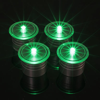 Four green LED lights on a black background