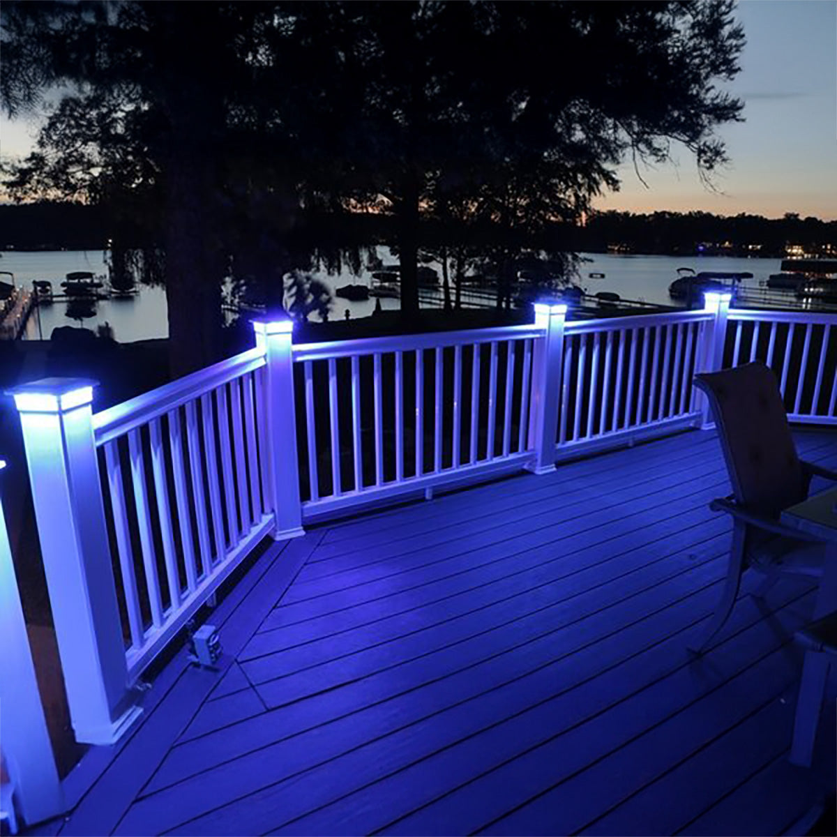 Deck with blue LED lights overlooking a lake at night