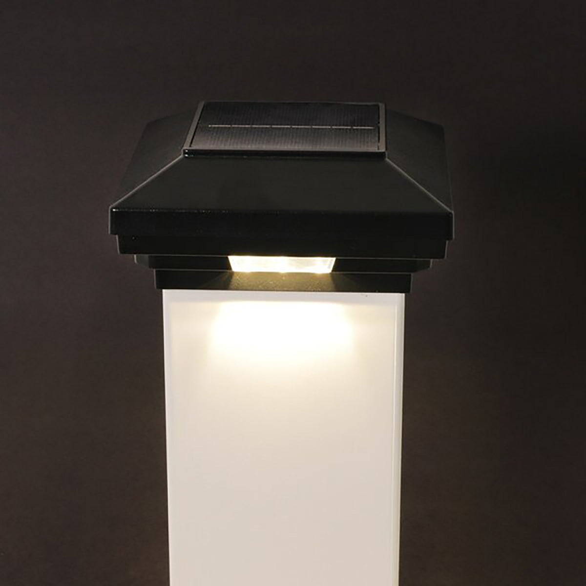 Black solar-powered outdoor light on a dark background