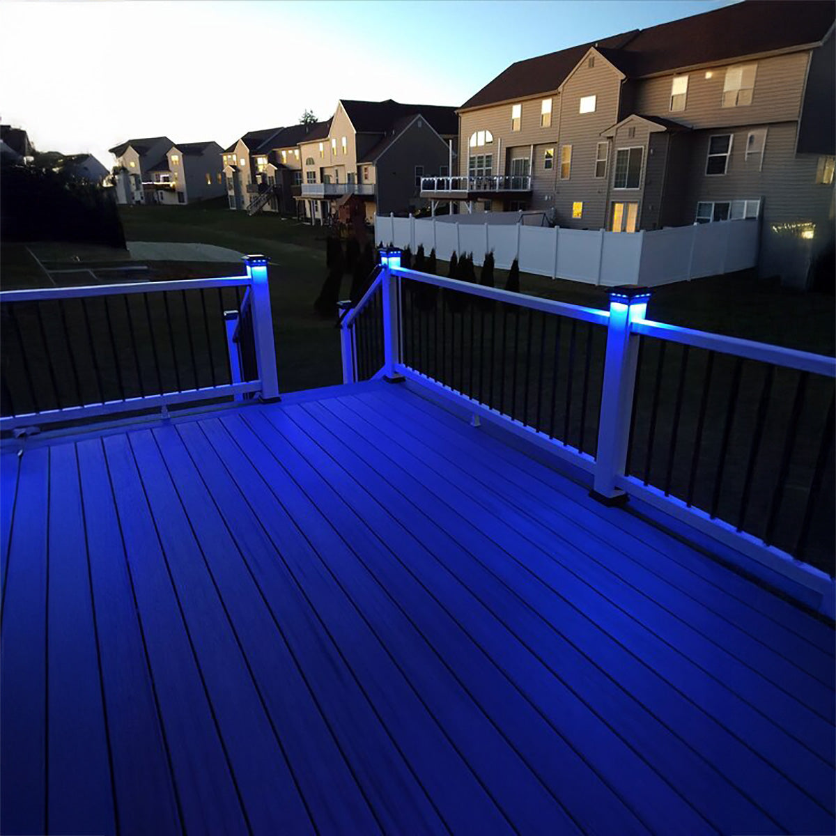 Blue LED lights on a deck with houses in the background
