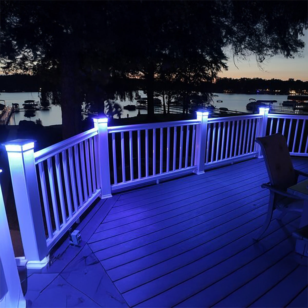 Deck with blue LED lights overlooking a lake at night