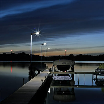 Dock with boats at night under illuminated streetlights