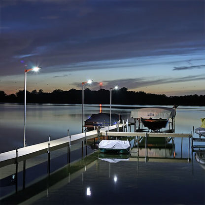 Dock with covered boats at night on a calm lake